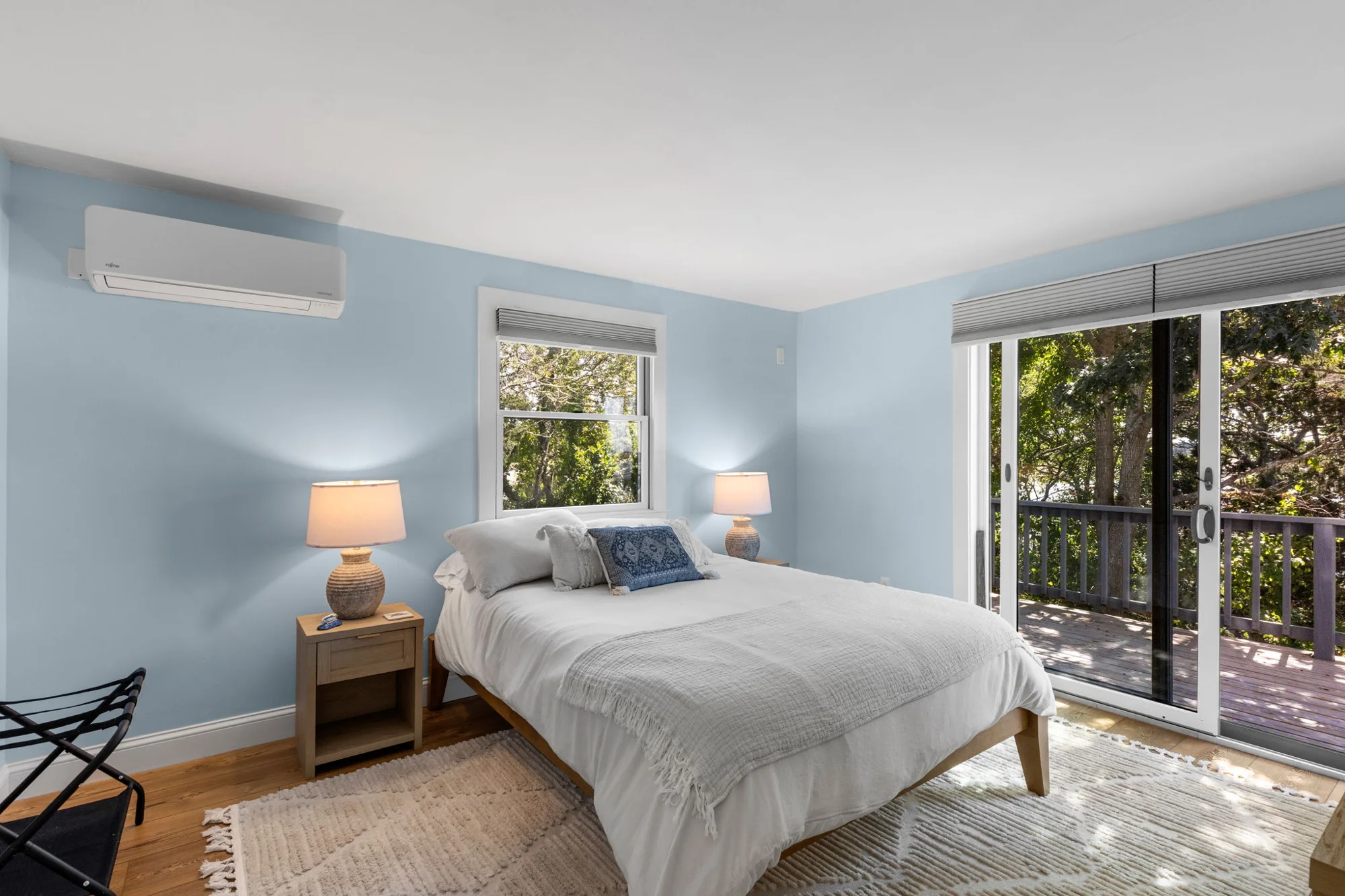 Pale blue bedroom with sliding doors to the deck