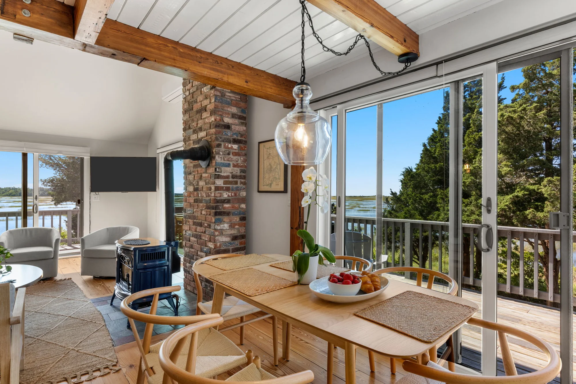 Dining table beside large windows and the living room