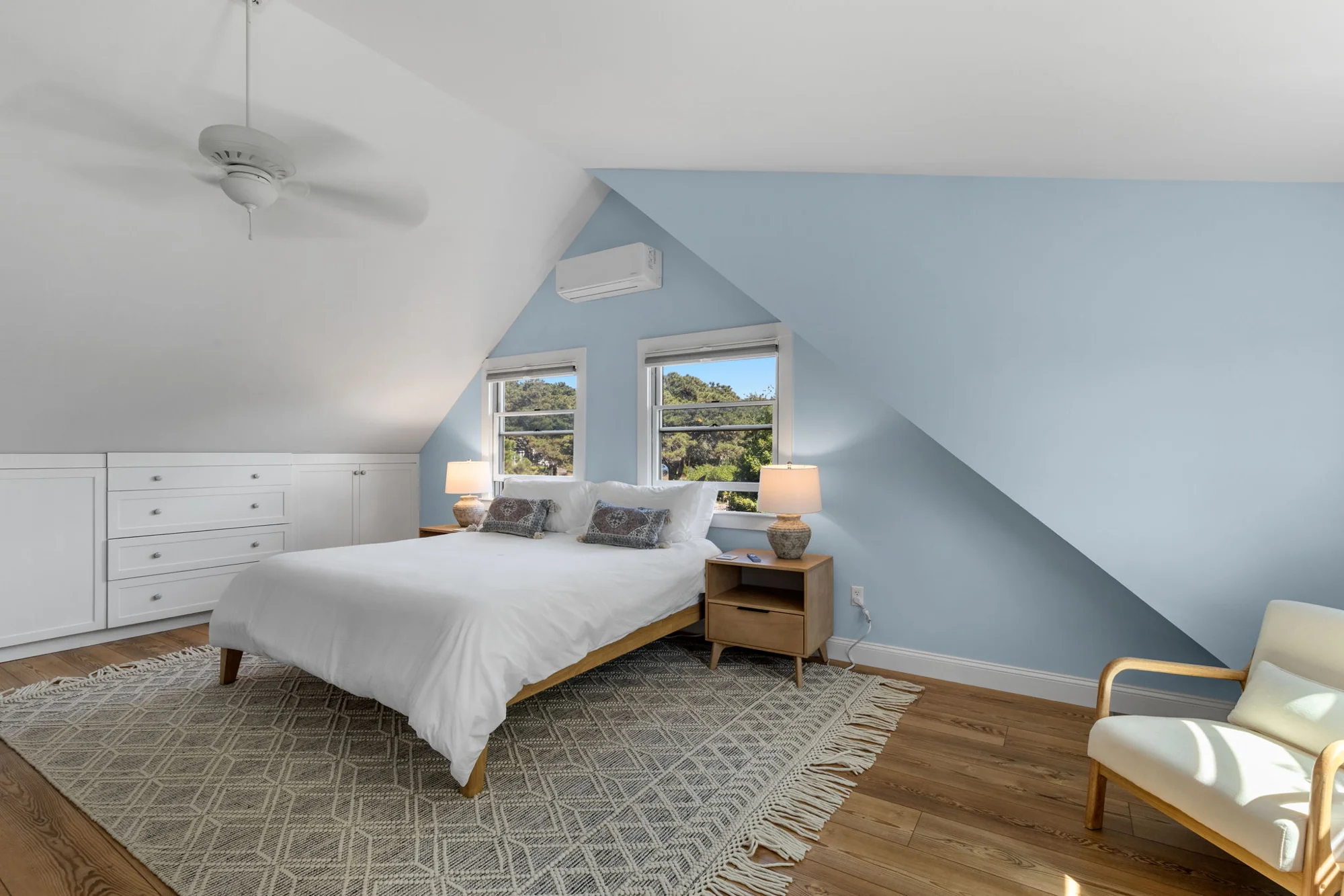 Upstairs bedroom with sloped ceiling and sitting area